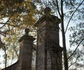 stone gate tree yellow leaves blue sky sunlight Royalty Free Stock Photo