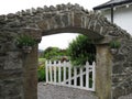 A stone gate with a white wooden door