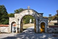 Stone gate with wooden door at the entrance to the Monastery St.George in Ajdanovac, Serbia. Royalty Free Stock Photo