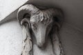 Stone goat head on the facade of the building. Animal art, ram head face eclectic antique reflief. Vintage sculpture, architecture