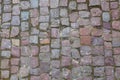 Stone granite cobblestoned pavement background or texture. Abstract background of old cobblestone pavement close-up in Prague Royalty Free Stock Photo