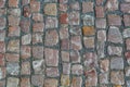 Stone granite cobblestoned pavement background or texture. Abstract background of old cobblestone pavement close-up in Prague Royalty Free Stock Photo