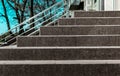 Stone granite stairs steps background with metallic aluminium handle. Red brown modern stairs. Entrance to the shop in