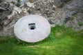 Stone granite wheel with rusted metal rim isolated on green grass. Royalty Free Stock Photo