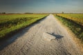 Stone in a gravel road, horizon and sky