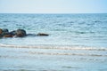 Stone groynes, breakwaters in the water off the coast in Denmark. Sunny day Royalty Free Stock Photo