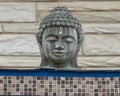 Stone head of Buddha outside of the Cosmic Cafe on Oak Lawn in Dallas, Texas.