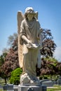 Stone Headstone of Angel Holding a Book Writing With Feather Quill Royalty Free Stock Photo