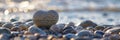 Stone Heart on Pebble Beach, Shining Ocean Water, Rocky Shore Love Symbole, Summer Pebble Heart Royalty Free Stock Photo