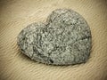 Stone heart standing on beach sand. 3D illustration