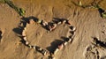 Stone heart on the wet and wet sand of the city river Bank on a Sunny summer evening Royalty Free Stock Photo