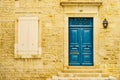 Stone house with blue door and shutters window Royalty Free Stock Photo