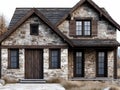 A stone house with a brown door and windows Royalty Free Stock Photo