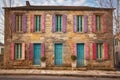 stone house facade with colorful window shutters Royalty Free Stock Photo