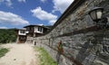 Stone house with stone fence in the Village of Leshten. Historical, facade. Royalty Free Stock Photo