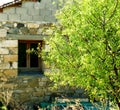 Stone House And Half Part Of A Tree