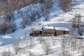 Stone house on snowy slope in Italy. Royalty Free Stock Photo