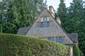 Stone house surrounded by a tall neat hedge in the unspoilt picturesque Cotswold village of Stanton in Gloucestershire UK. Royalty Free Stock Photo