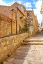 Stone houses along a narrow street in the old part of Dubrovnik city. A tourist sits and relaxes. Old town. Croatia Royalty Free Stock Photo