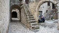 Stone houses in narrow street of old town, beautiful architecture with archs and stairs, sunny day, Trogir, Dalmatia, Croatia Royalty Free Stock Photo