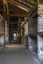 Stone hut with wooden shelves in the concentration camp Royalty Free Stock Photo