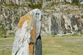 Stone idol on a meadow surrounded by mountains, Altai, Russia