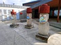 Stone idols in masks. Covid-19. France, 2020 Royalty Free Stock Photo