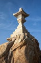 Stone lantern on boulder near Take Island in Gamagori, Japan