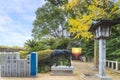 Stone lantern in front of a divine Shinme horse bronze statue in Japanese Miyajidake Shrine.