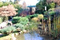 A Stone Lantern And The Garden With Maple