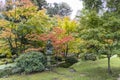 Stone lantern in a Japanese Garden of an English Park. Royalty Free Stock Photo