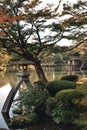 Stone lantern and a lake in the most beautiful garden in Japan Kenrokuen in Kanazawa Royalty Free Stock Photo