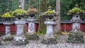 Stone lanterns with refreshing green moss on gravel yard in japanese temple garden for background Royalty Free Stock Photo