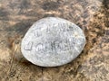 A stone left by a fan of Queen on the bronze plinth of the Freddie Mercury statue in Montreux, Switzerland. Royalty Free Stock Photo