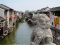 Stone lion on a bridge over a water channel in Suzhou Royalty Free Stock Photo