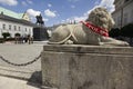 Stone lion figure near equestrian statue of Prince Jozef Poniatowski in front of Presidential Palace in Warsaw, Poland Royalty Free Stock Photo