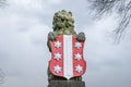 Stone lion holding the coat of arms of Gouda