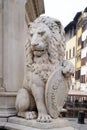 Stone lion holding shield outside of the of Basilica of Santa Croce in Florence