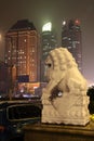 Stone lion and skyscrapers