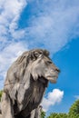 Stone lion. Stone statue of a lion against the blue sky