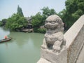 Stone lion statue on bridge in Wuzhen, China. Royalty Free Stock Photo