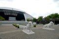 Stone lion statues standing guard in front of the steel dome of Singapore National Stadium, Kallang