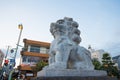 Stone lion and Tori gate in front of Dankazura pathway to Tsurugaoka Hachimangu shrine