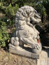 Stone lions on a bridge in a garden