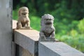Stone lions on a bridge in a garden