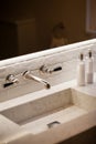 Washroom basin with wall mounted tap