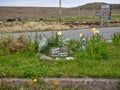 A stone marks the site of the John Peel Memorial Traffic Island at Baltasound on the island of Unst in Shetland, UK