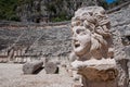 Stone mask and ancient amphitheater, Myra (Turkey) Royalty Free Stock Photo