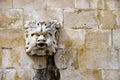 Stone mask figure on ancient fountain, architectural detail of o