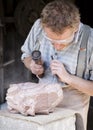 Stone Mason sculpting a slab of granite